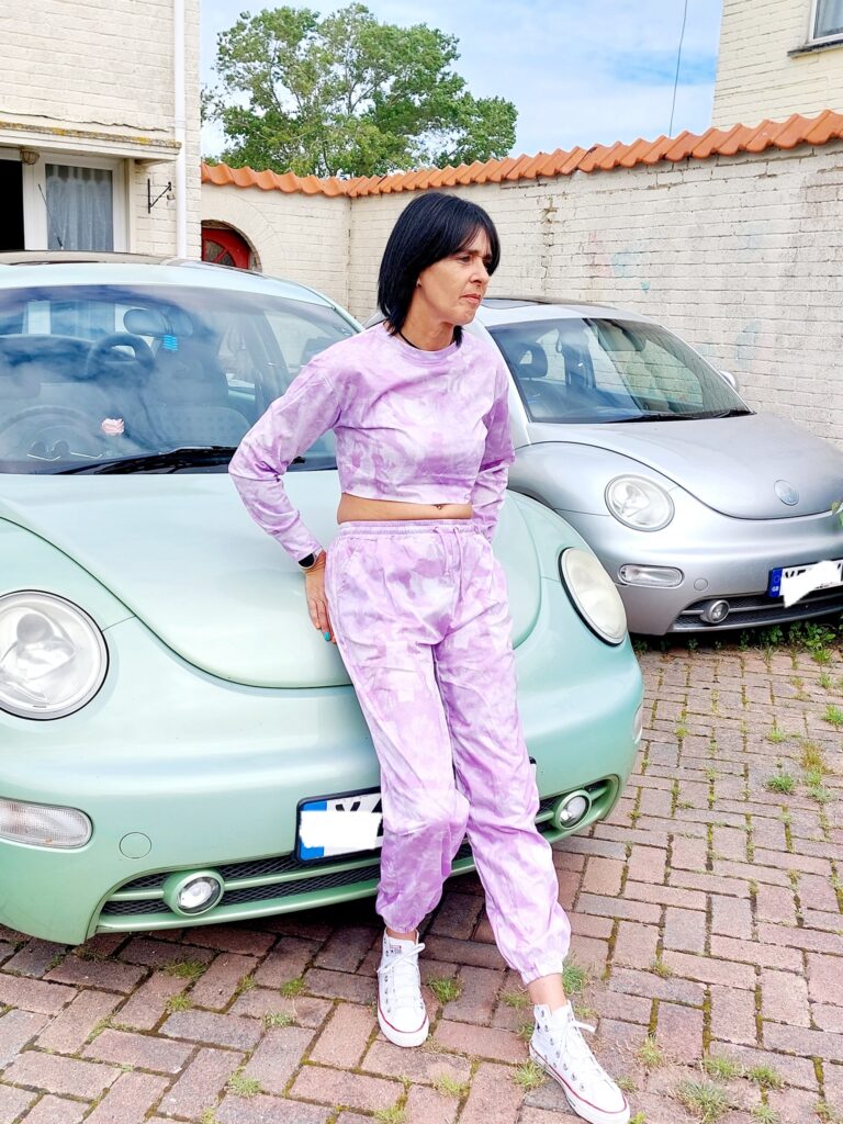 Lady leaning in a green beetle car whilst wearing Purple Tie Dye Oversized Sweatshirt Co-ord