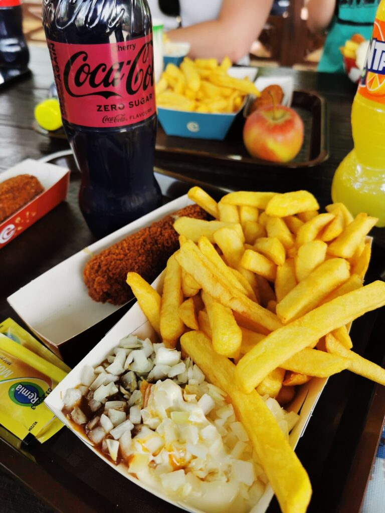 a bottle of coke zero, a dutch sausage snack and some fries. All in a takeaway box